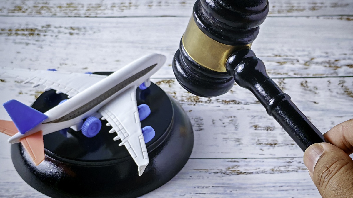 Aviation Legal Regulation: Judge's Gavel Hovering Over Miniature Airplane Model